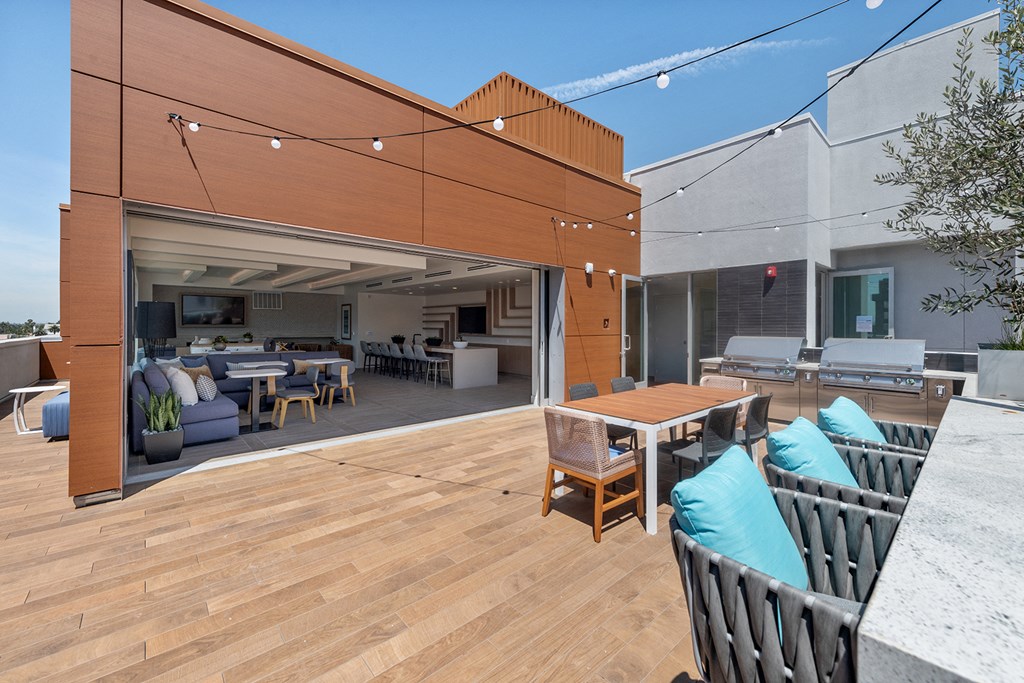 a large deck with a table and chairs and a patio