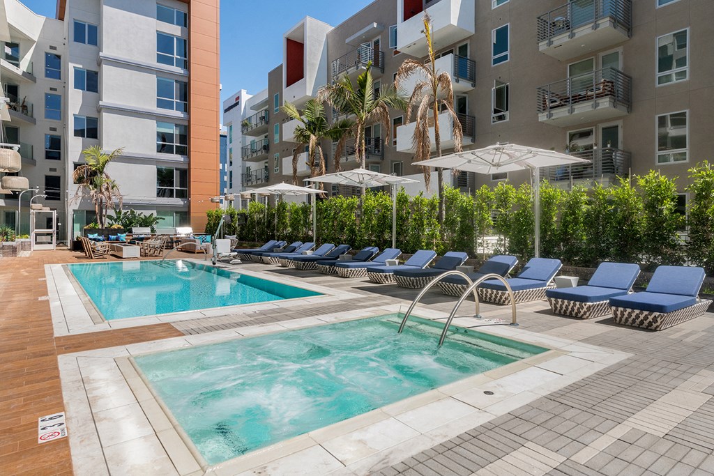 a swimming pool in front of an apartment building