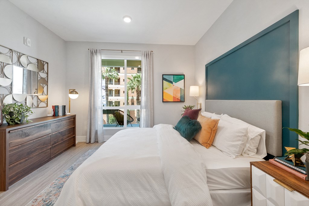 a bedroom with a large bed and a window