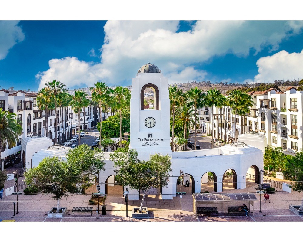 rior Entrance with Clock Tower, Benches, Landscaping, and Palm Trees at The Promenade Rio Vista, San Diego, California