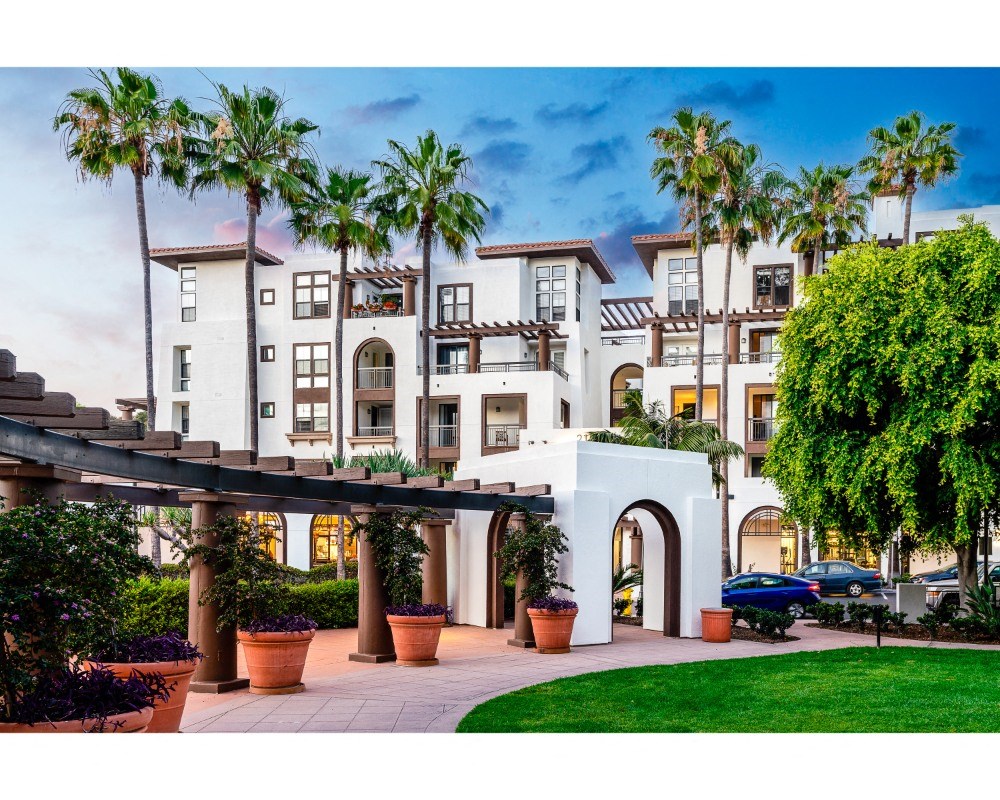 exterior of apartment building with palm tree landscaping at The Promenade Rio Vista, San Diego, CA