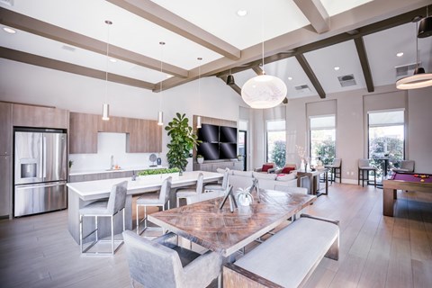 A modern kitchen with a dining table and chairs.
