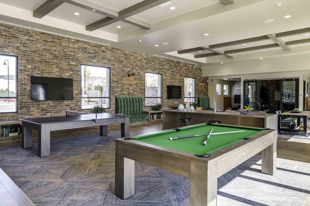 our apartments showcase a large game room with pool tables and a flat screen tv