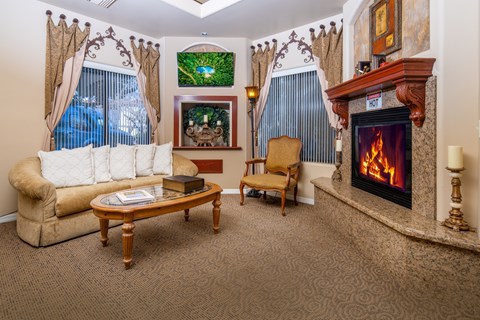 A living room with a fireplace and a painting on the wall.