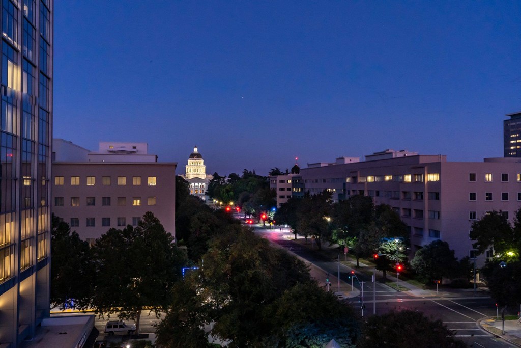 a city at night with the capitol building in the background