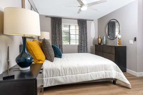 Bedroom with gray walls and white bedding at Toscana at Rancho Del Rey Apartments, California, 91910