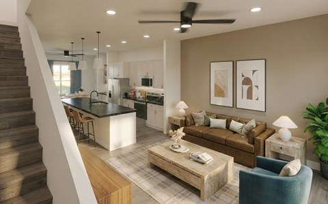 A modern living room with a staircase on the left side.