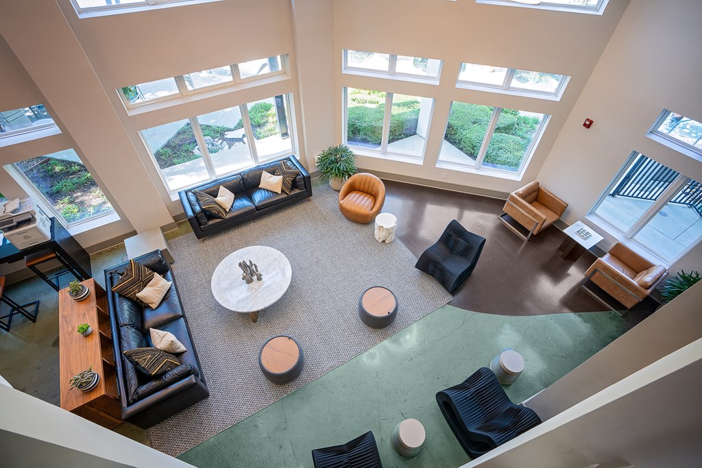 View of lobby from above with chairs and couches and tables with lots of windows at Trend Design District, Dallas