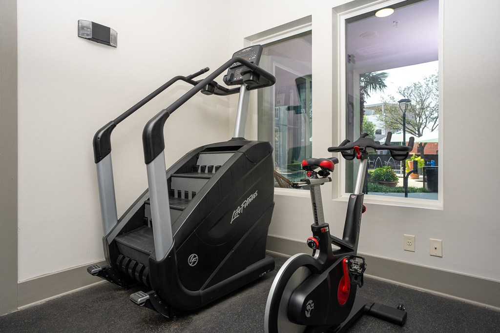 a treadmill and elliptical machines in a gym at Trend Design District, Dallas, TX