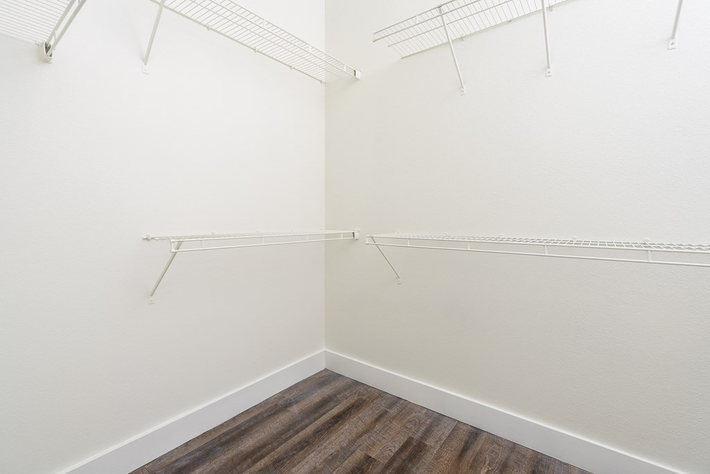 a walk in closet with shelves at Trend Design District, Dallas, 75207