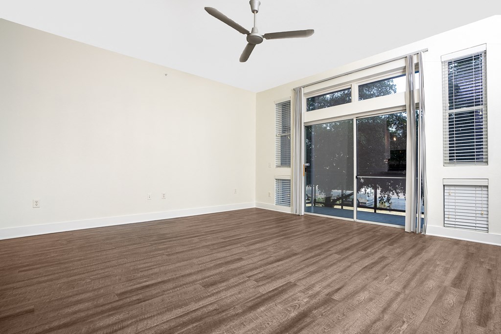 a bedroom with hardwood floors and a ceiling fan at Trend Design District, Texas