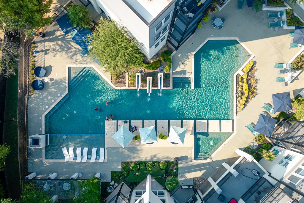 view of resort style pool with lounge chairs at Trend Design District, Texas 75207