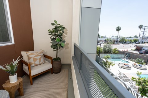 Private balcony overlooking pool deck and courtyard at Trestle Apartments, Monrovia