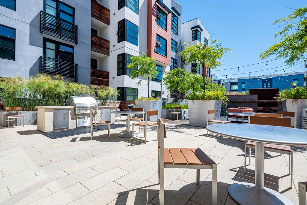 Outdoor Grill Area Surrounded by Lounge Seating, Tables, and Landscaped Grounds at Venue, San Francisco, CA, 94158