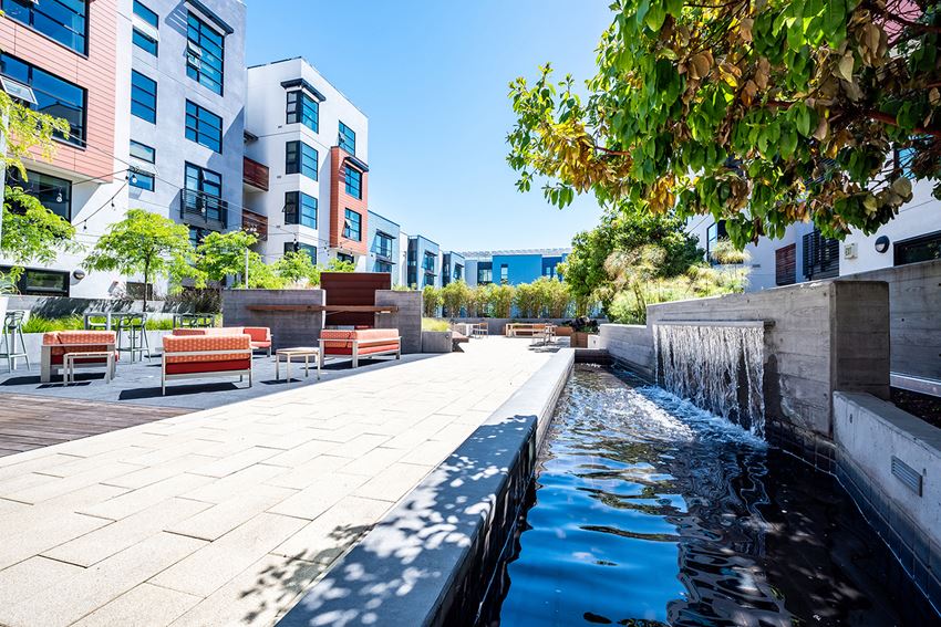 Luxury Apartments for Rent in San Fransisco CA - Outdoor Courtyard With Plenty of Seating And Trees, Surrounded By A Decorative Fountain With A Walking Path.