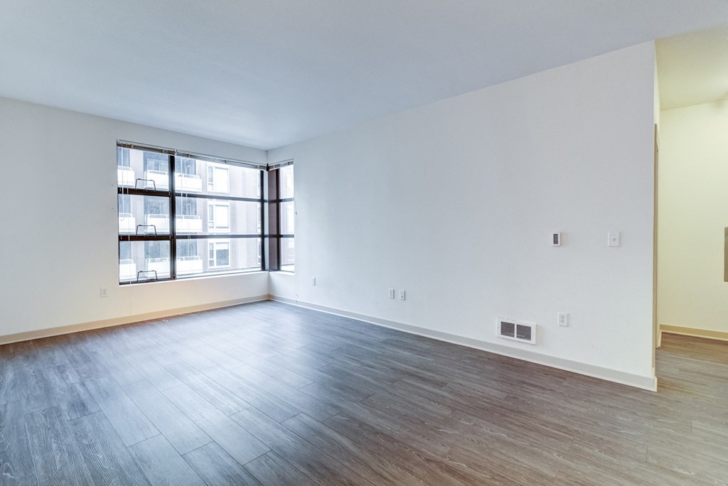 Empty Living Room with Hardwood-Style Flooring and a Large Window at Venue, San Francisco, CA