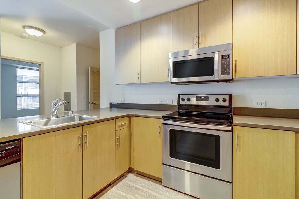 a kitchen with stainless steel appliances and wooden cabinets at Venue, San Francisco, California