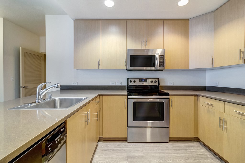 a modern kitchen with stainless steel appliances and wooden cabinets at Venue, San Francisco, 94158