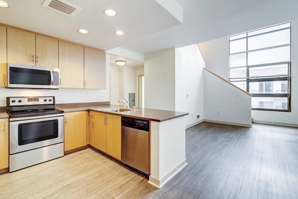 an empty kitchen with wood flooring and a large window at Venue, San Francisco, 94158