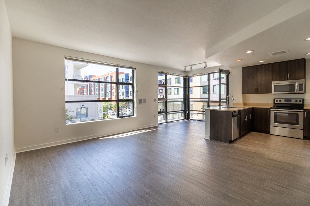 A spacious kitchen with dark wood cabinets and stainless steel appliances.