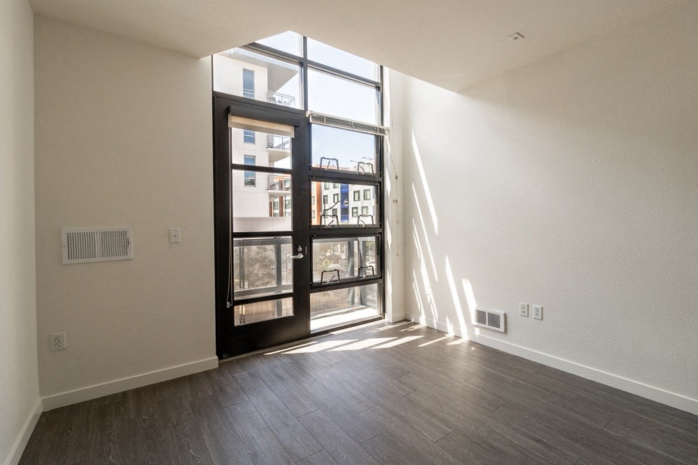 A room with a sliding door leading to a balcony.