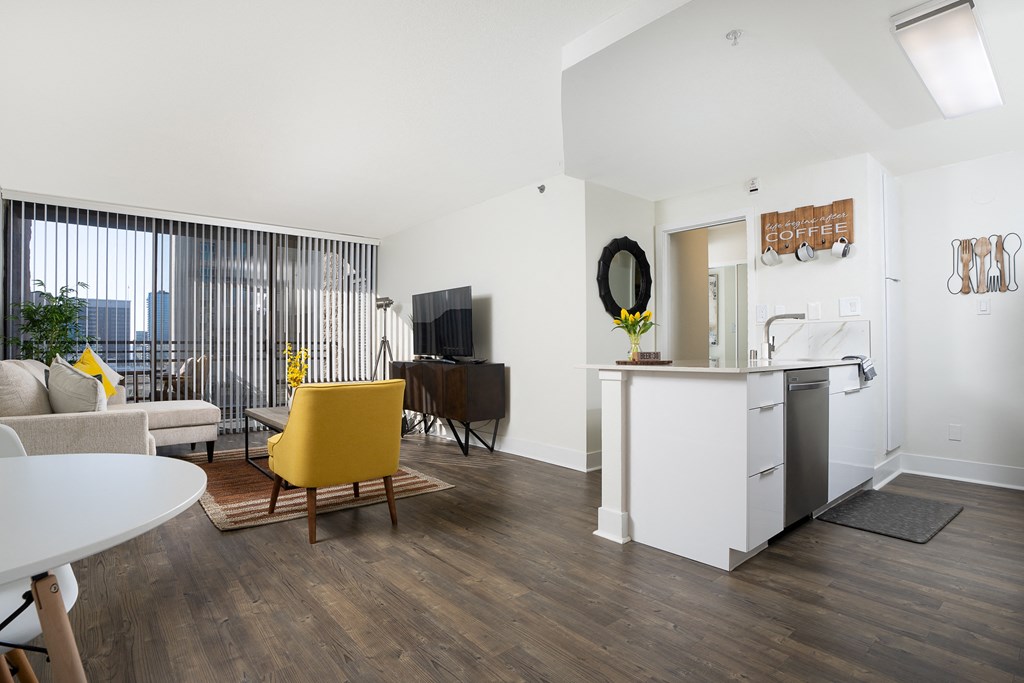 kitchen island and livingroom with seating and large windows