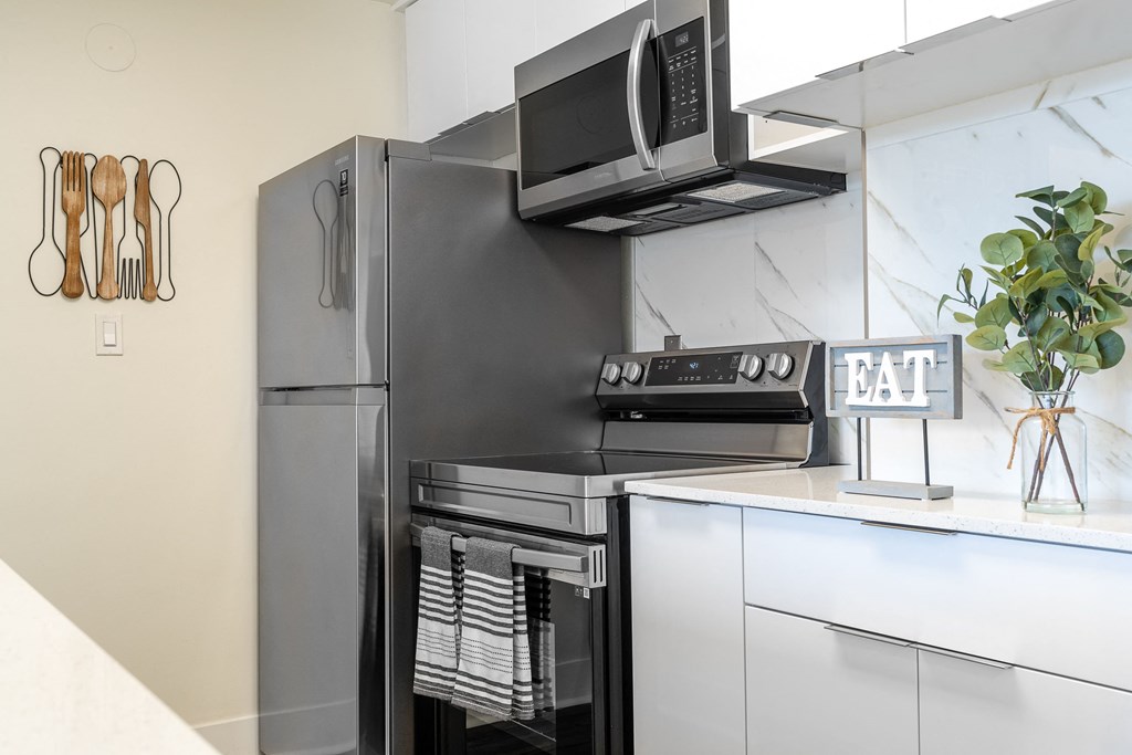 Kitchen with white cabinets with stainless appliances