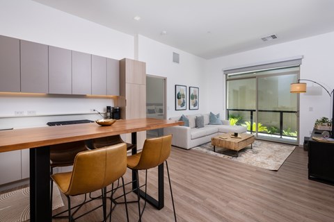 A modern kitchen with a dining table and chairs.
