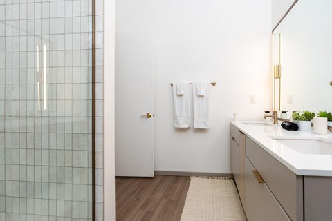 Bathroom with tiled shower and sink