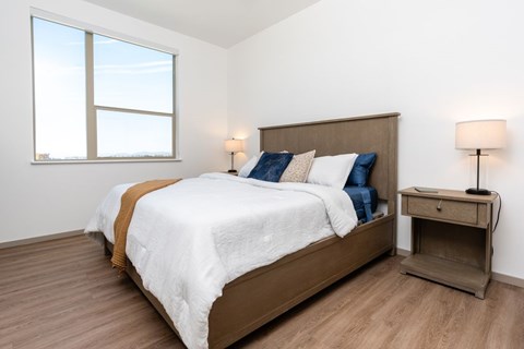A bedroom with a large bed and a window.