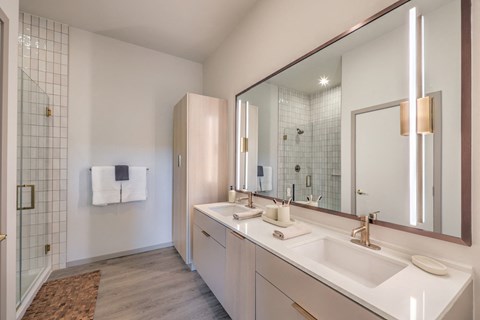 a bathroom with two sinks and a large mirror