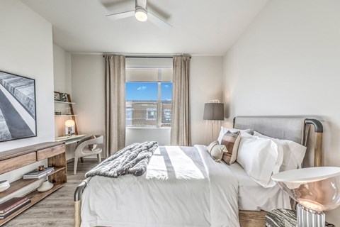 a bedroom with a large bed and a window