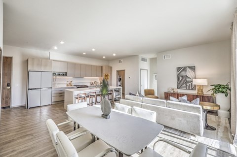 a living room with a dining table and a kitchen