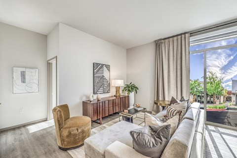 a living room with a large window and a couch