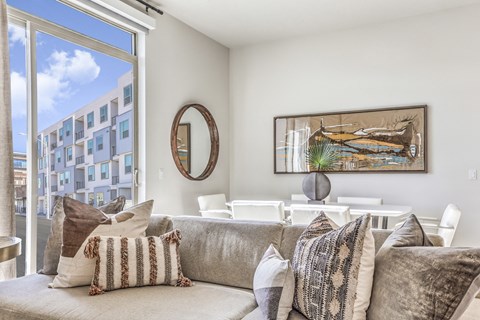 a living room with a couch and a large window