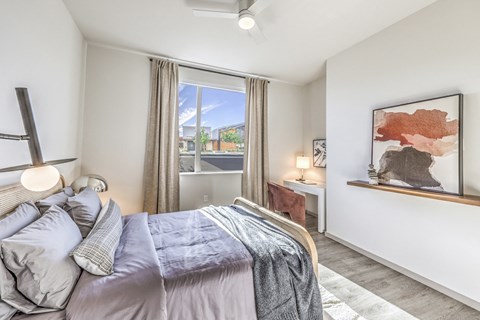 an open bedroom with a bed and a window