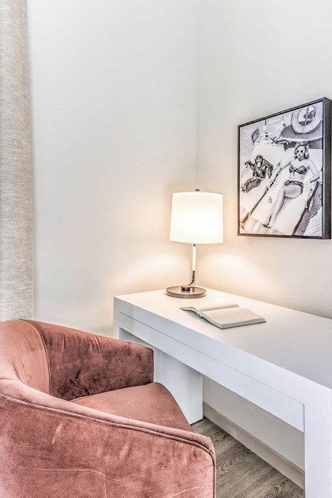 an office with a chair and a desk with a lamp