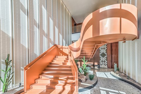 a spiral staircase in a lobby of a vestra