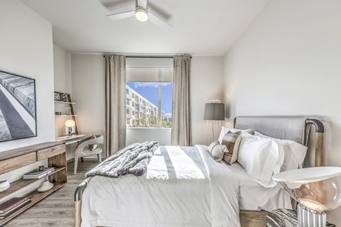 a bedroom with a large bed and a window