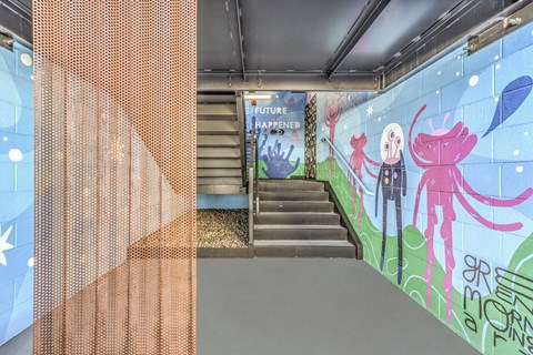 a stairwell with a mural on the wall