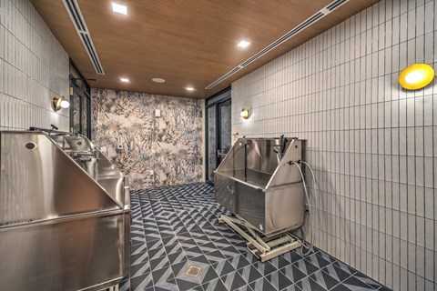 A kitchen with a tiled floor and a wallpapered wall.