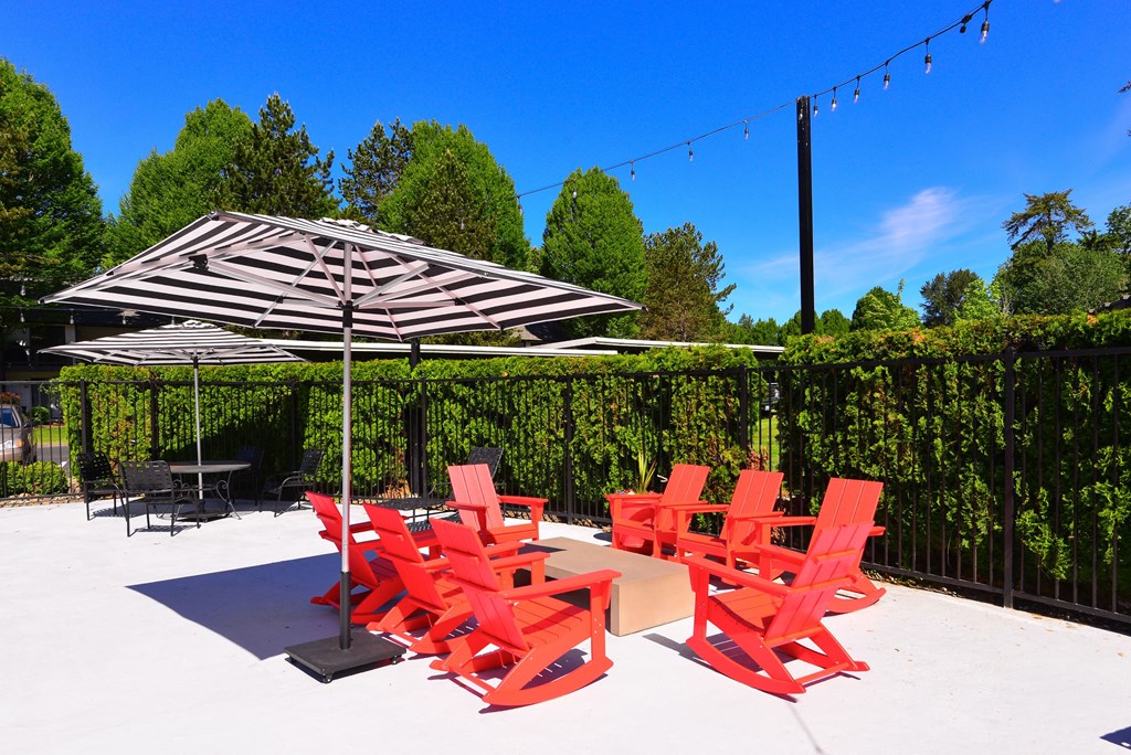 Outdoor seating with umbrella at Woodlake Apartments, Kirkland