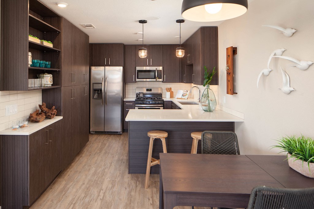 Kitchen with stainless steel appliances and dining area