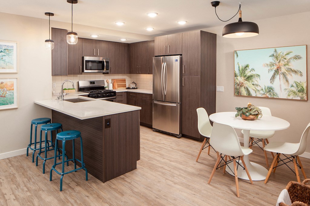 Kitchen with stainless steel appliances and dining area