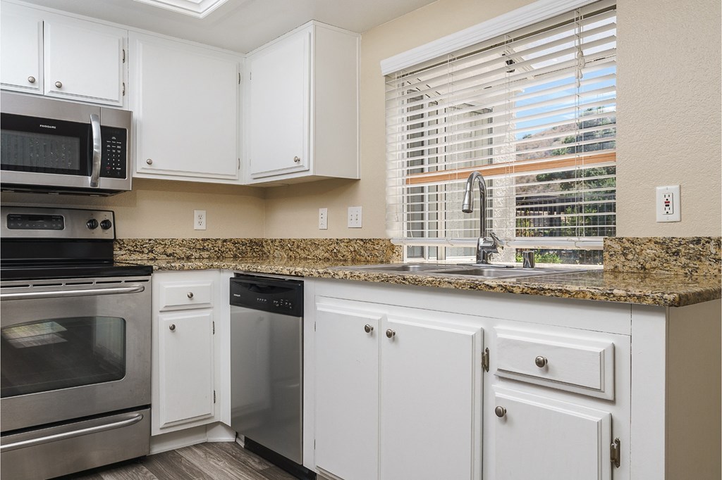 renovated kitchen with white cabinets