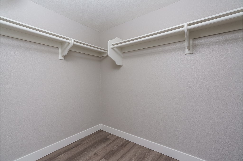 renovated walk in closet with plank style flooring