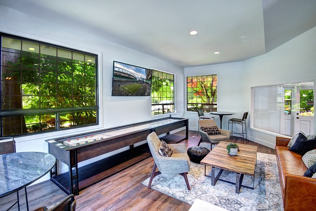Indoor Clubhouse With Convenient Kitchenette, Flat Screen TV, and Ample Comfortable Seating at Woodlake Apartments, Washington 98034