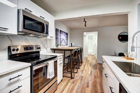 a kitchen with stainless steel appliances and a dining room table