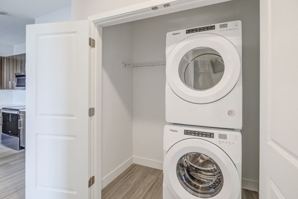laundry closet with stacked washer and dryer