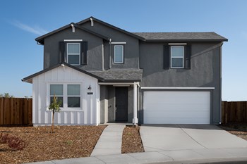 front exterior of two story model with garage and front yard - Photo Gallery 4